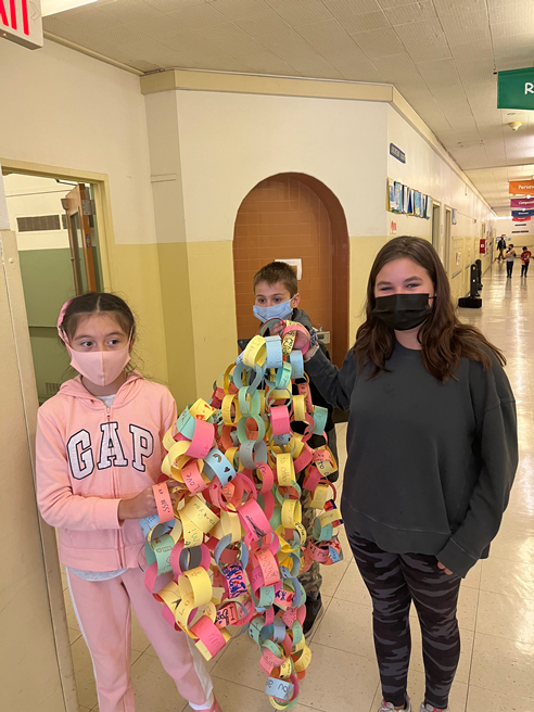Students hold up the kindness chain for a photo
